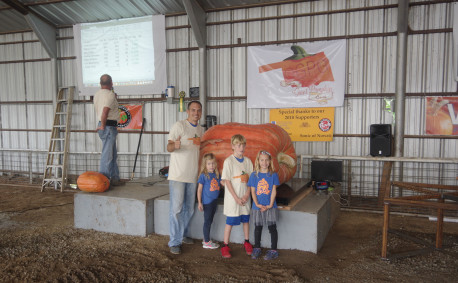 Jacob and the kids pose with their giant pumpkin.