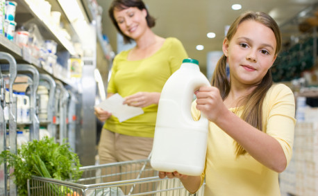 mom and daughter buying milk