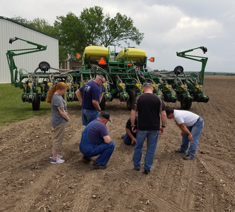 Veterans at the SAVE Farm in Manhattan learning to plant beans